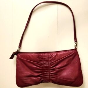 Apostrophe Wine Genuine Leather Shoulder Bag Trim is Man-Made.